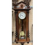 A mahogany cased Vienna style wall clock approximately 110cm long complete with winding handle
