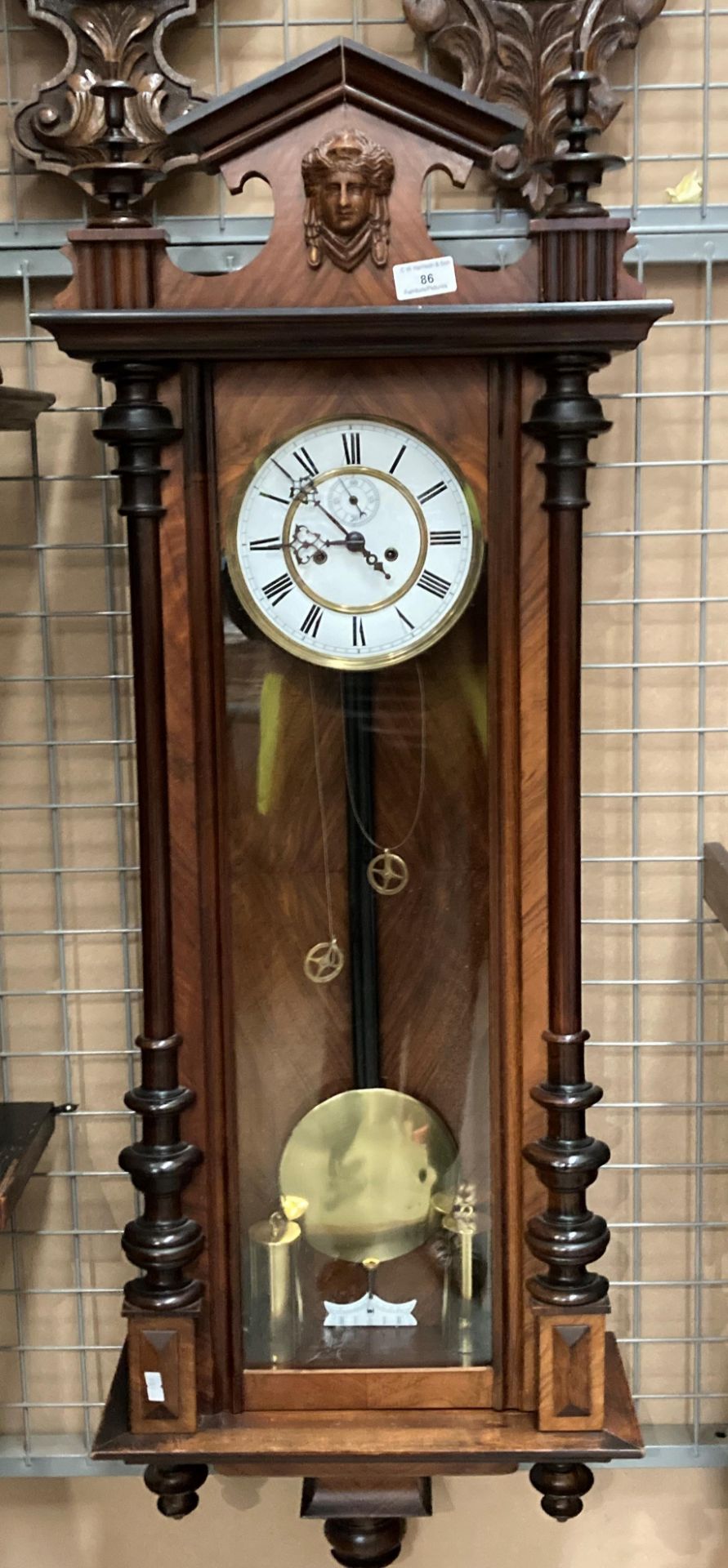 A mahogany cased Vienna style wall clock approximately 110cm long complete with winding handle