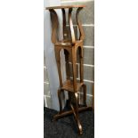 A tall oak finish plant stand with two under trays 34cm diameter x 130cm high