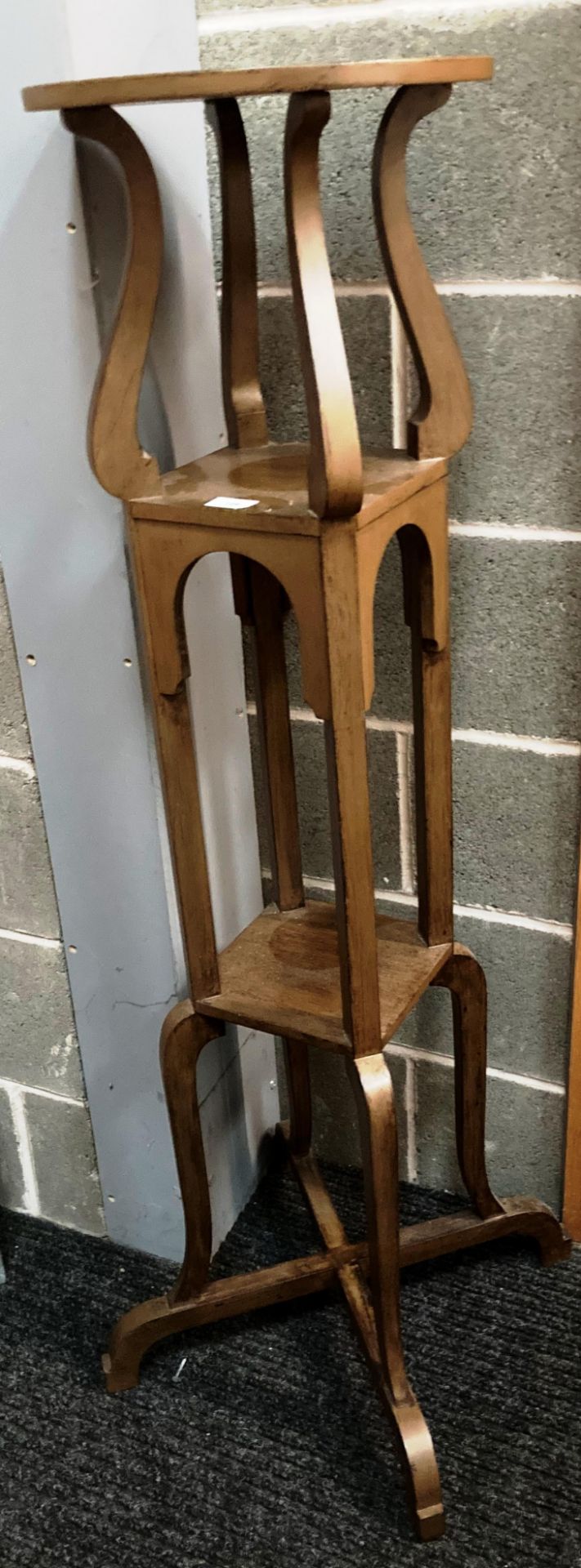 A tall oak finish plant stand with two under trays 34cm diameter x 130cm high