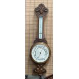 An oak cased wall barometer 80cm long