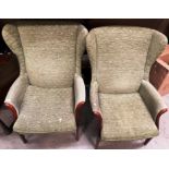 A pair of Parker Knoll green pattern upholstered wing back armchairs complete with fire