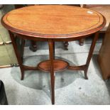 An oak framed oval side table with undershelf 72cm