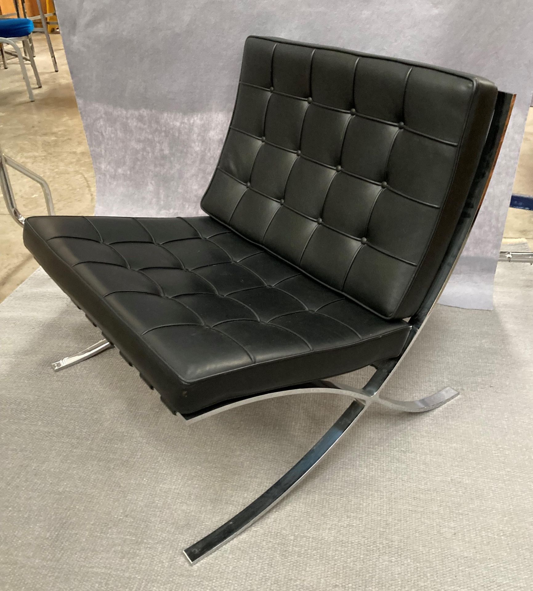 A KNOLL STUDIO BARCELONA CHAIR with padded black leather upholstery on chrome frame 75cm wide,