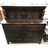 A dark oak sideboard with two upper doors over two drawer two door base 130 x 130cm high (max)