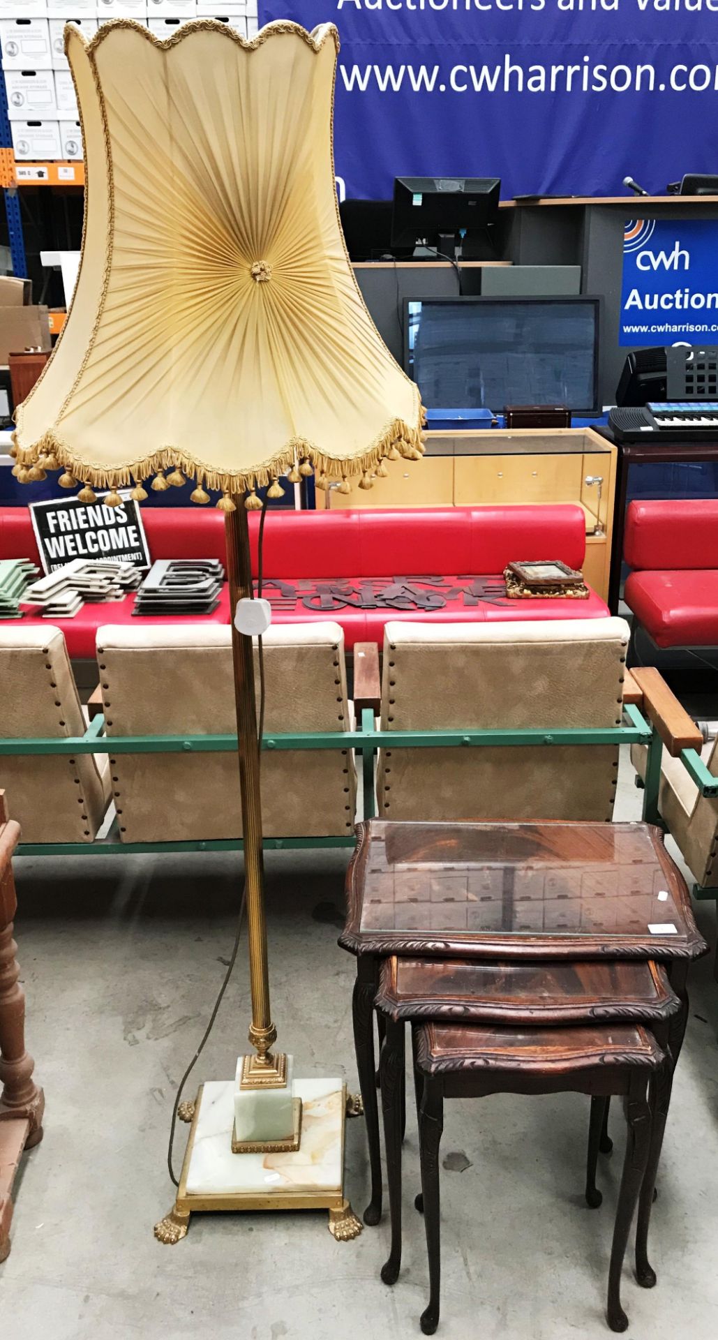 A nest of three mahogany coffee tables with inset glass tops and a brass and onyx standard lamp