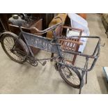 A black metal shop keepers delivery bike with front basket holder with metal sign 'Marlbeck'