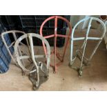 Four wall mounting metal saddle racks one with metal label Mabbotts Manchester