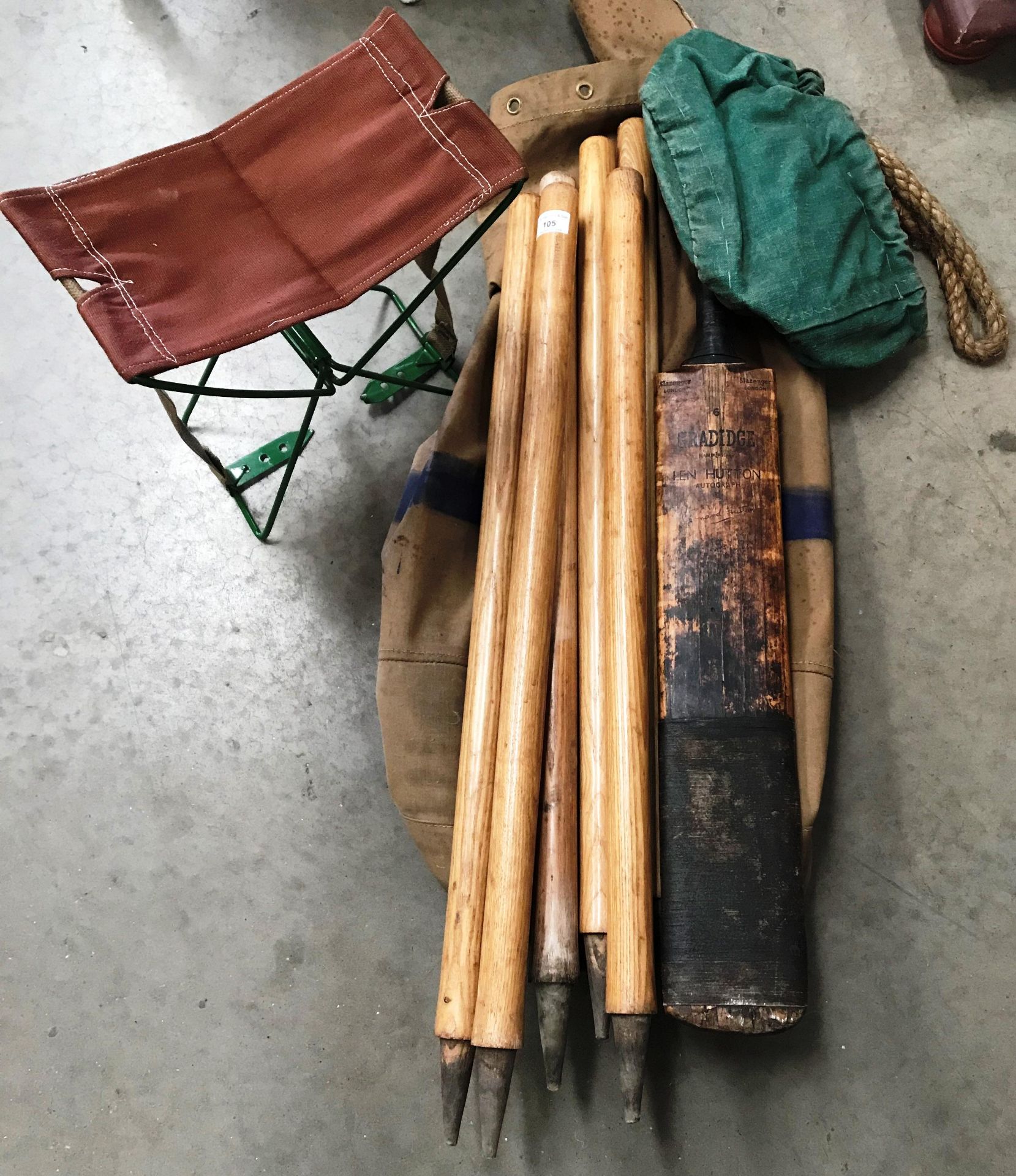 A kit bag containing a Slazenger Gradidge 'Len Hutton' child's cricket bat, six cricket stumps,