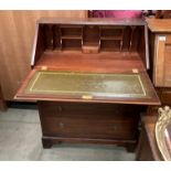 A mahogany finish bureau with flap fall over three drawers and a half moon hall table (mahogany