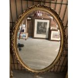 Oval ornate gilt framed mirror 85 x 58cm