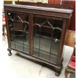 A mahogany china cabinet with a short back over a blind frieze and two tracery glazed doors