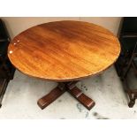 A Titchmarsh and Goodwin circular oak single pedestal dining table 110cm diameter and four non