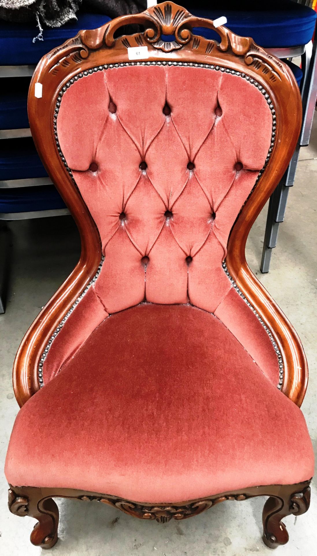 A reproduction mahogany framed nursing chair with pink dralon upholstery