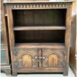 A carved oak side cabinet with a shelf over two doors 78cm x 92cm high