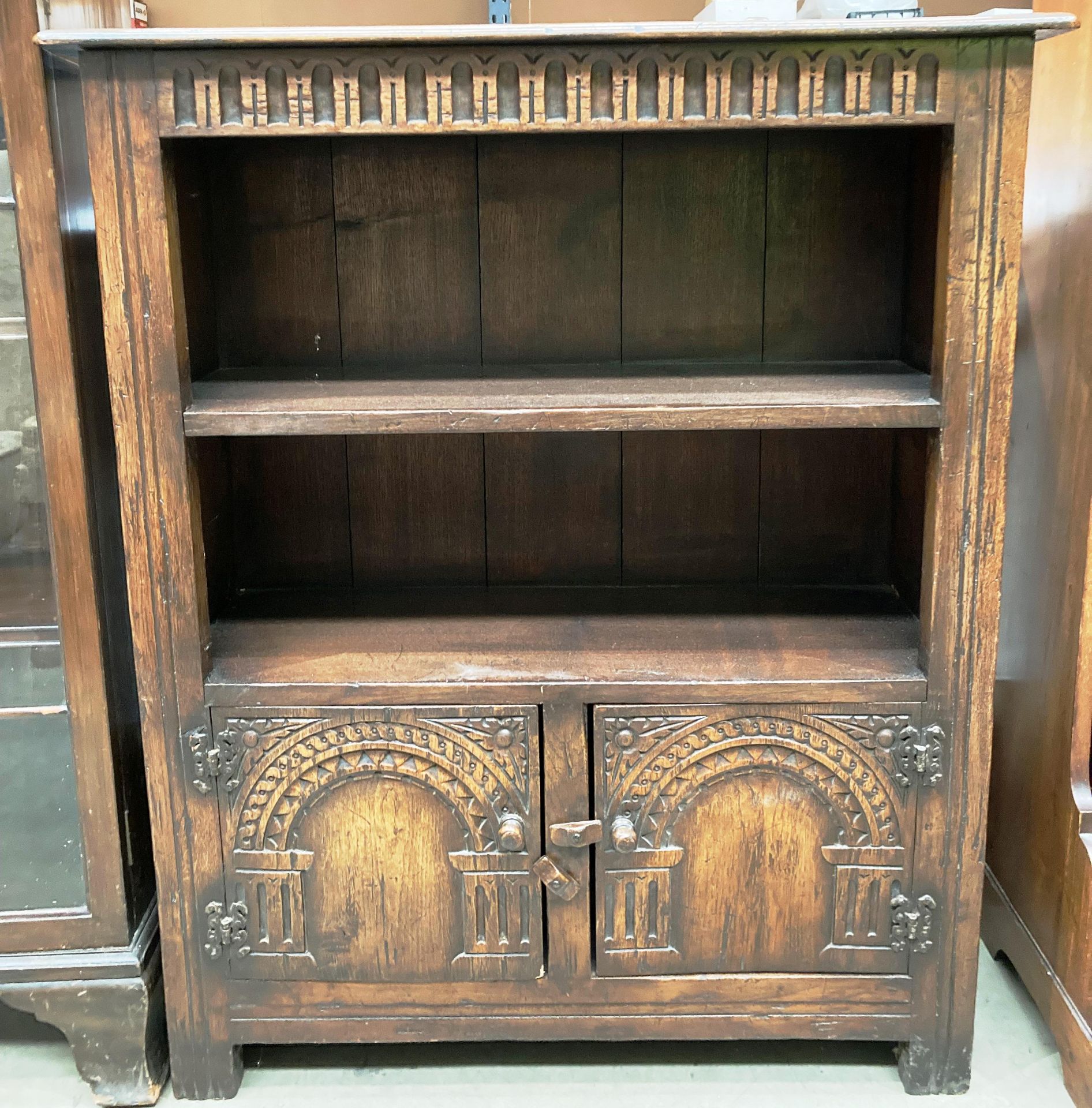 A carved oak side cabinet with a shelf over two doors 78cm x 92cm high