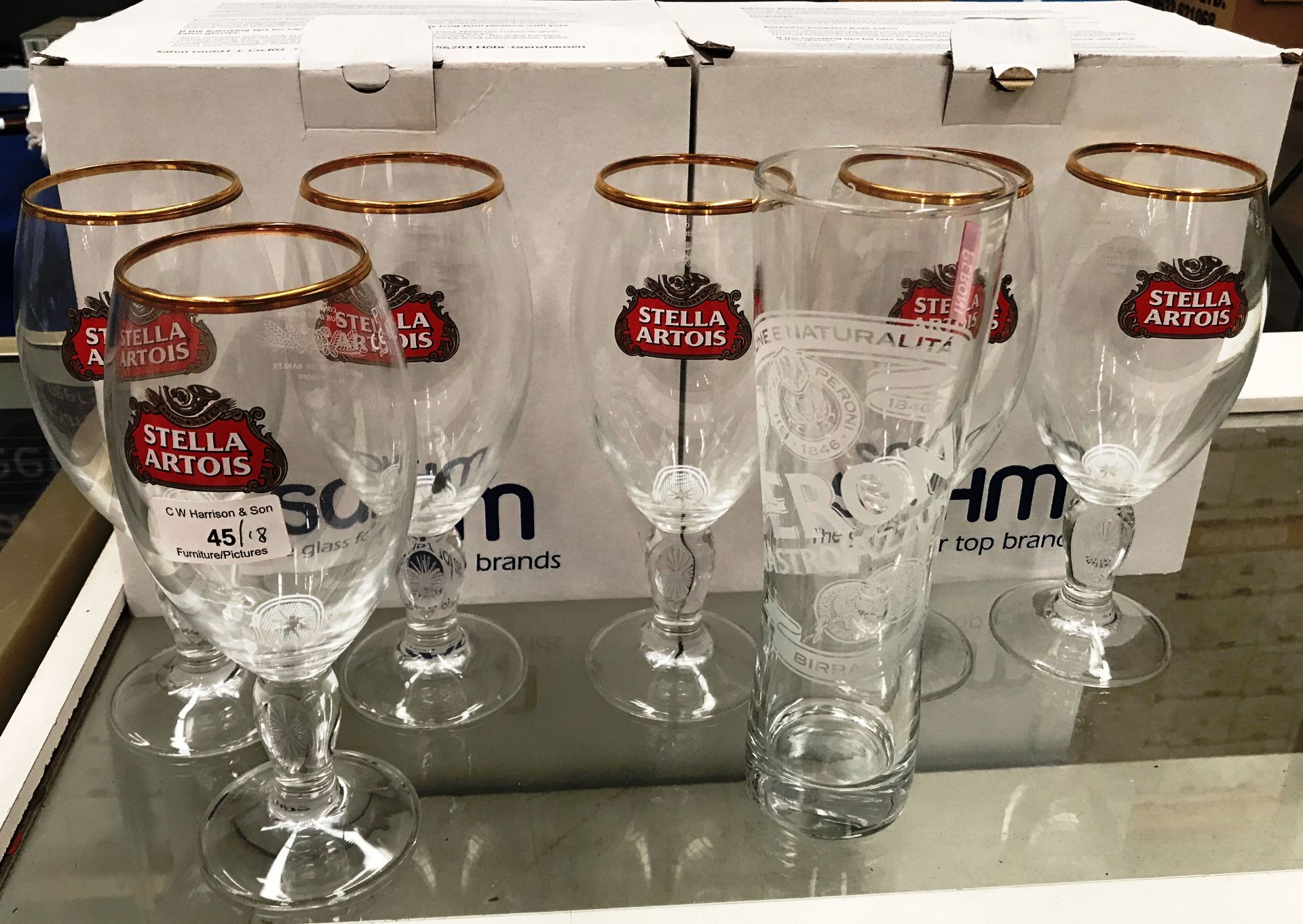 Twelve Peroni pint glasses (boxed) and six Stella Artois pint glasses (18)