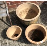 A set of three graduated ceramic planters