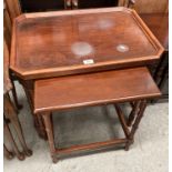 A nest of two mahogany finish coffee tables