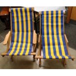Two modern wood framed deck chairs with blue and yellow striped seats