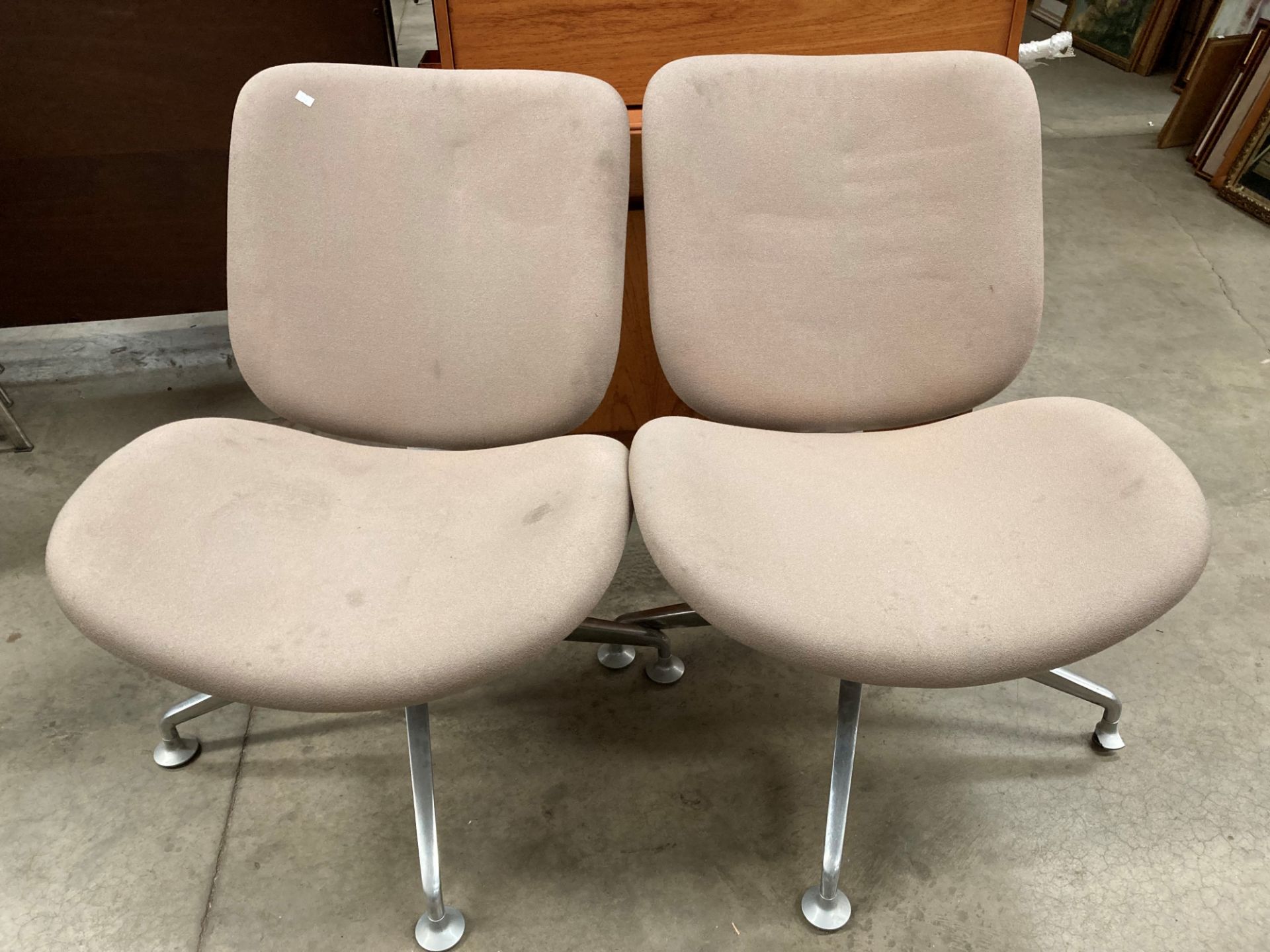 A pair of Orangebox Model Track - 02 beige upholstered swivel chairs on four star chrome cases