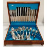 A wooden canteen of cutlery containing fifty eight pieces of Moss Rose plated and Smith Seymour