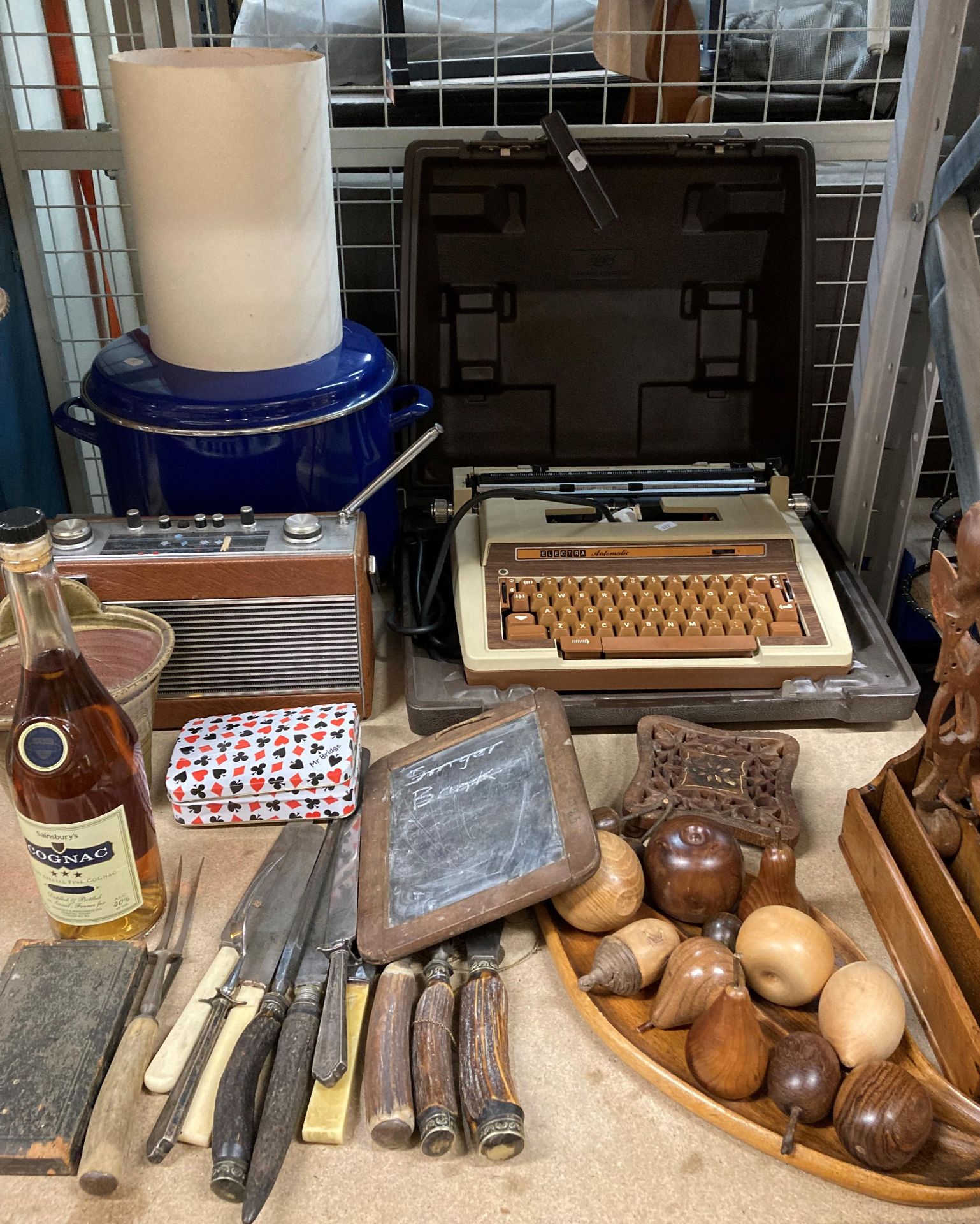 Contents to part of rack - cased Electra Automatic typewriter, wooden fruit, carving sets,