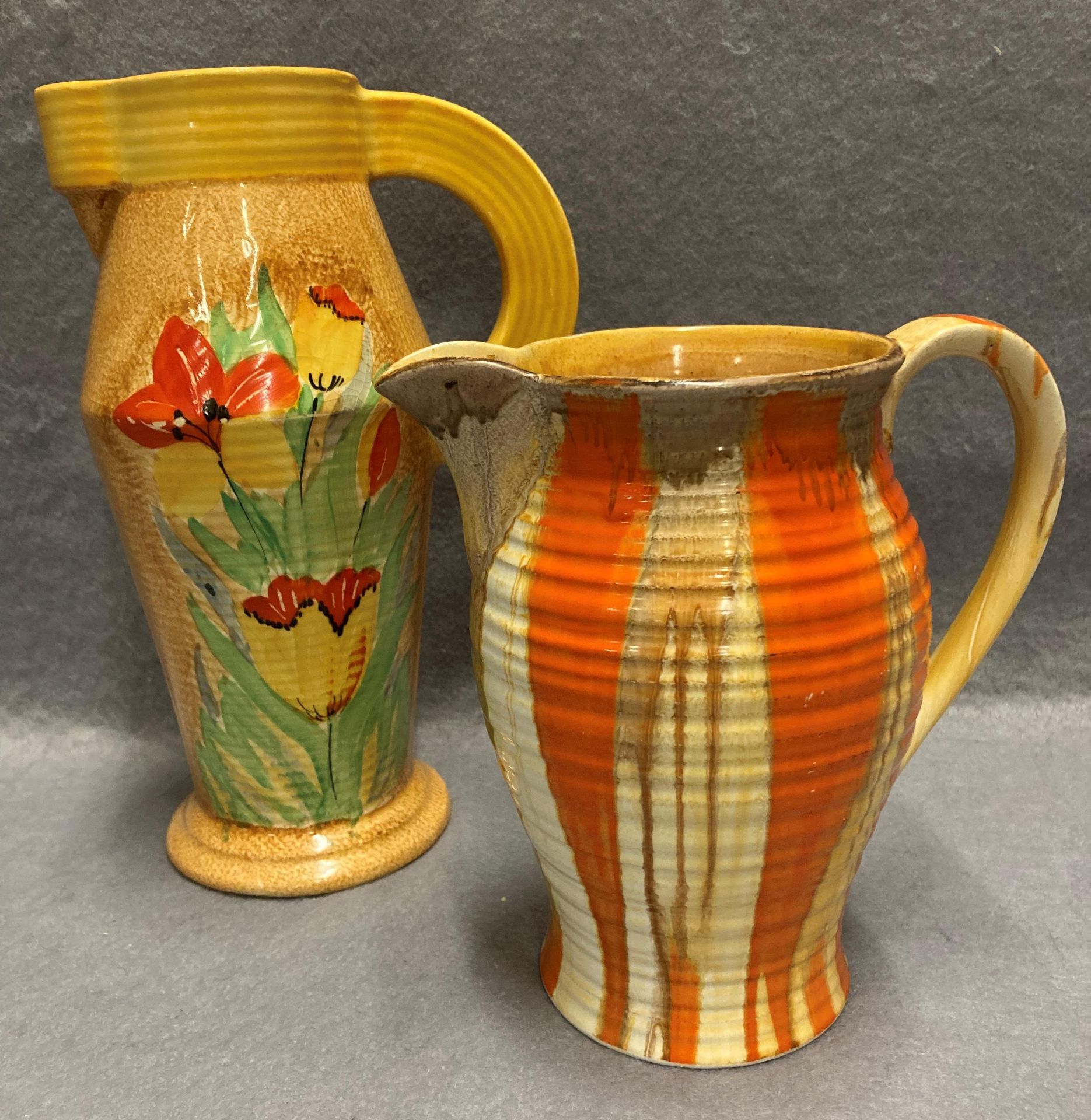 A Shelley jug in orange, yellow and brown, together with a Wadeheath jug with floral decoration, no.