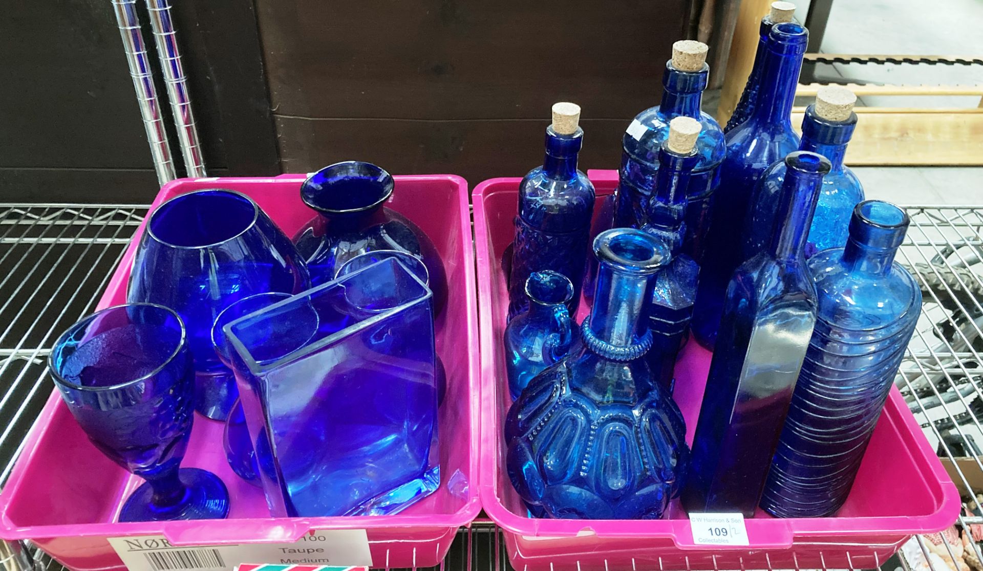 Contents to two purple plastic trays - a selection of blue glass bottles and vases