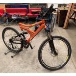 A Carrera Hellcat Shimano Diore 18 speed front and rear suspension mountain bike in orange with