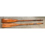 Two wooden lacquered oars,