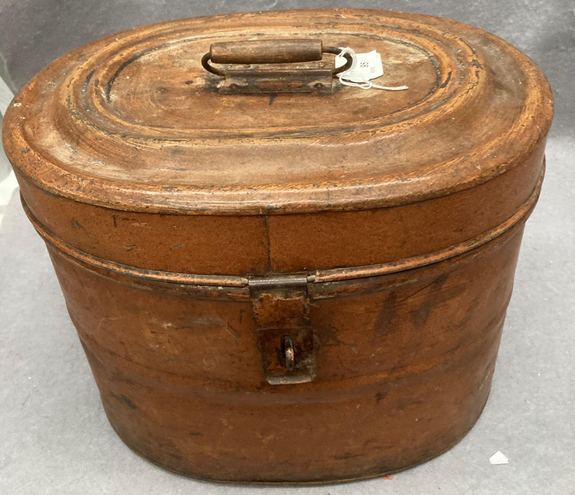 A brown metal top hat box