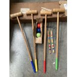 Wooden croquet set including four mallets, four balls, two centre pegs and nine metal hoops,