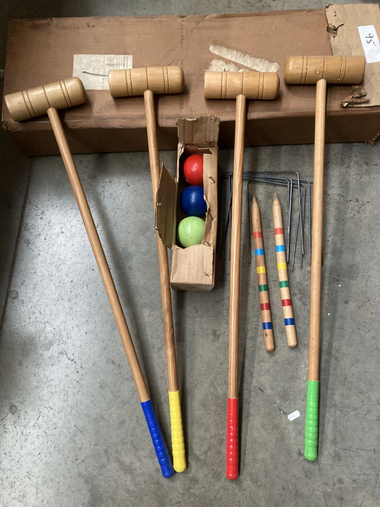 Wooden croquet set including four mallets, four balls, two centre pegs and nine metal hoops,