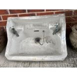 A vintage white glazed sink 60cm complete with two taps