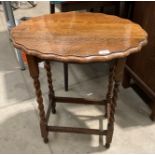 An oak oval side table on barley twist legs 60 x 45cm