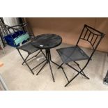 Small three piece patio set comprising black metal circular table 48cm dia and two black metal