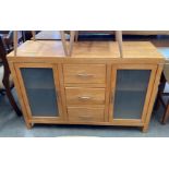 A pine finish three drawer two glazed door sideboard 120cm long