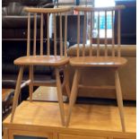 A pair of wooden stick back kitchen chairs