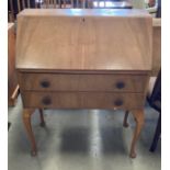 A walnut bureau with fall flap over two drawers 76cm