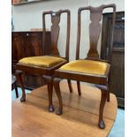 A pair of mahogany Queen Anne style dining chairs with mustard upholstered seats