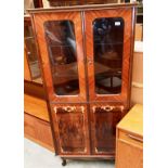 A modern Italian gloss walnut finish corner cabinet on short cabriole legs with two glazed doors