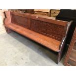 A stained pine pew,