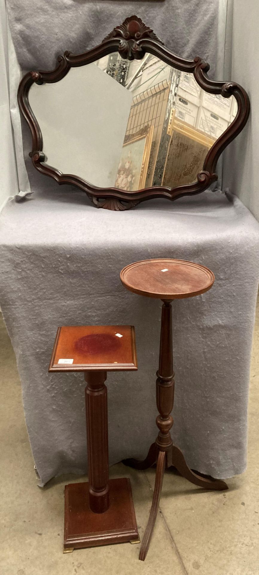 Two mahogany finish plant stands and a shaped wall mirror (3)