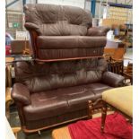 Burgundy leather three seater and two seater settees with wood trim [Please note - the upholstery