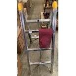 An aluminium framed three tier trestle complete with purple canvas bag