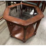 A dark wood finish octagonal side table with glass insert top and undertray 63cm dia