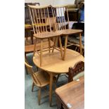 A pine finish formica topped circular kitchen table 92cm dia together with four blond elm stick