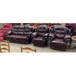 A Mansfield Upholstery oxblood leather upholstered three piece suite comprising three seater settee