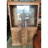 A large pine vivarium with two glass sliding doors over two door, four drawer base,